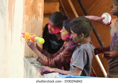 PUNE, INDIA- March 20, 2018, Kids Playing HOLI Indian Color Festival. Throwing Water Balloons 