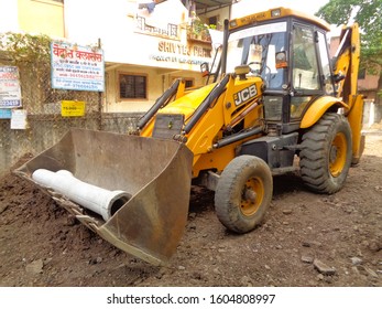 Pune, MH/INDIA- Jan 03, 2020: An Excavator Is Working In Residential Area For Paving Out Sewer Line.