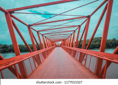Punggol, Singapore, 3 March 2017: The Lorong Halus bridge, red design bridge pedestrian connecting Punggol town to Lorong Halus Wetland. (Unseen in Singapore, process in orenge and teal HDR)