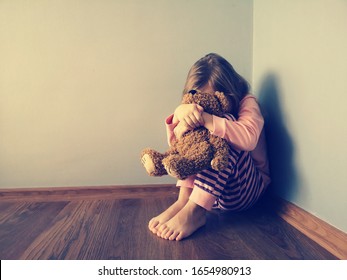 The punished child sits cowering in the corner, hugs his toy and cries.  Concept: incorrect parenting, mistakes in education.