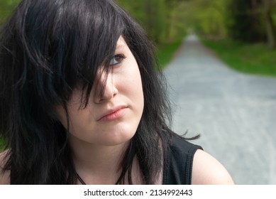 Punk Emo Girl, Young Adult With Black Hair And Eyeliner, Looking Away, Outdoors, Close-up, Horizontal