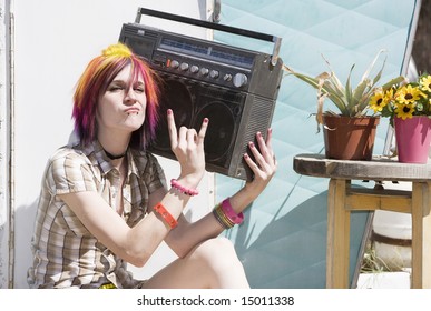 Punk Girl With Brightly Colored Hair Sitting On Trailer Step Holding Boom Box