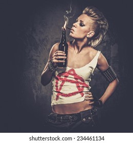 Punk girl with a Molotov cocktail - Shutterstock ID 234461134