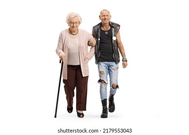 Punk man helping a senior woman with a walking cane isolated on white background - Shutterstock ID 2179553043