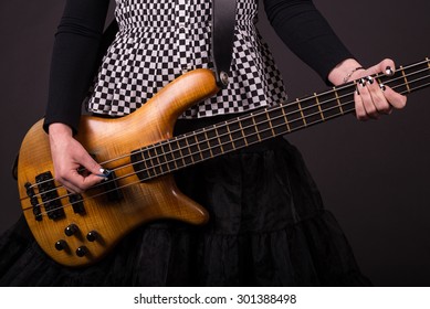 Punk Rock Girl Playing Bass Guitar Closeup 