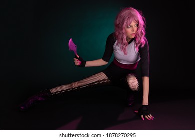 Punk rock sexy female assassin with pink hair wearing black, holding a weapon