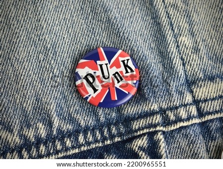 Punk rock union flag pin badge on a vintage rockers denim jacket coat 1980s Great Britain colours with room for copy text