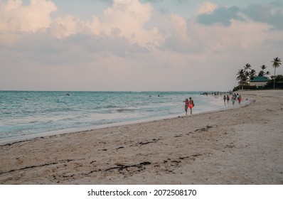 Punta Cana - Bávaro, Dominican Republic - October 22, 2021 - A Couple Walking On The White Bavaro Beach At Sunset