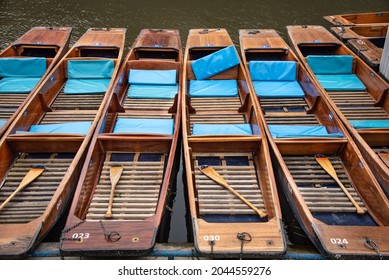 Punts parked up at the river in Cambridge on a cloudy day, Cambridgeshire, UK.
