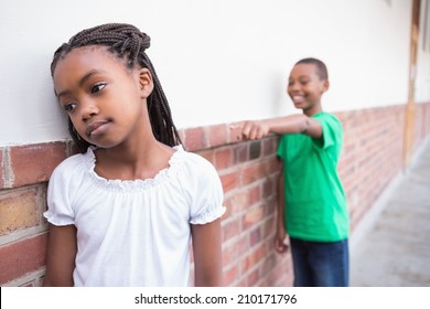 Pupil Bullying Another In The Hall At The Elementary School