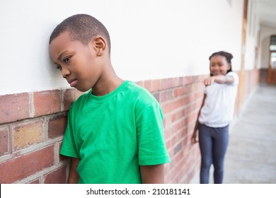 Pupil Bullying Another In The Hall At The Elementary School