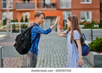 Pupil Friends Greeting Near School With Backbacks.