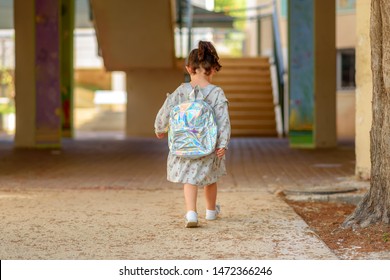 Pupil Kid Going To School In First Class With Holographic Schoolbag Or Satchel, Child Walking To School Bus. Toddler First Day At School Or Preschool.