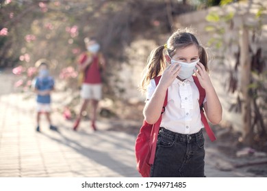 Pupil With Medical Mask On Face And Backpacks Outdoor. Education During Coronavirus Time. Children And Healthcare. Back To School.