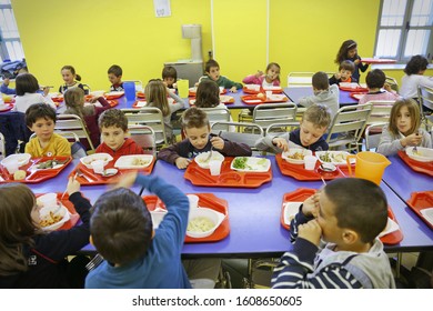 Pupils enjoying lunch in the school cafeteria. Milan, Italy - April 2017