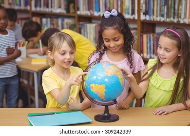 Pupils In Library With Globe At The Elementary School