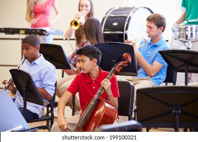 Pupils Playing Musical Instruments In School Orchestra
