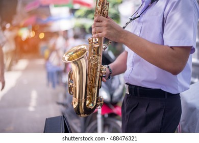 The Pupils Playing The Saxophone.close Up Student Playing The Saxophone