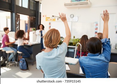 Pupils Raising Hands In A High School Science Lesson