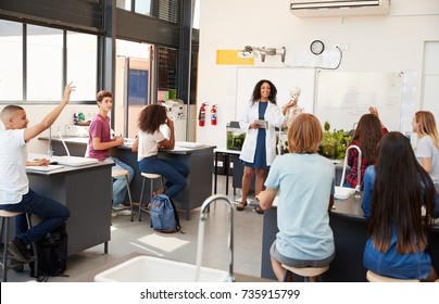 Pupils Raising Hands In A High School Science Lesson