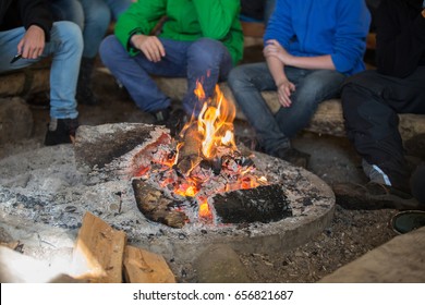 Pupils Sitting In Front Of A Campfire