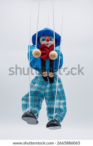 Puppet with blue and red strings, isolated on white