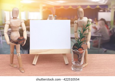 puppet doll ,canvas frame and coins in glass with blur meeting room background - Powered by Shutterstock