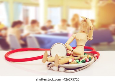 puppet doll ,medicine and stethoscope in dish with blur meeting room background - Powered by Shutterstock