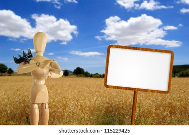 Puppet farmer with rake, blank sign and wheat field on background - Powered by Shutterstock