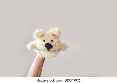 Puppet Show Dog On A Gray Background. Space For Text Or Replicas.