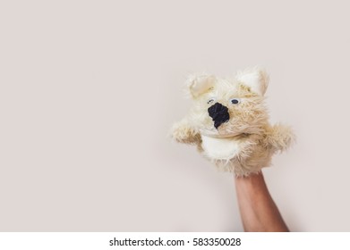 Puppet Show Dog On A Gray Background. Space For Text Or Replicas.