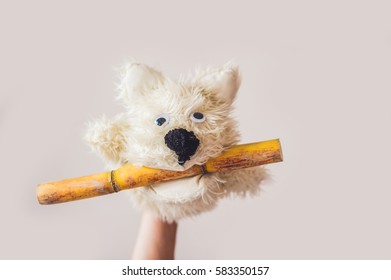 Puppet Show Dog On A Gray Background. Space For Text Or Replicas.