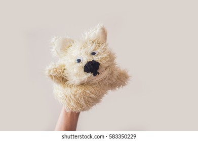 Puppet Show Dog On A Gray Background. Space For Text Or Replicas.