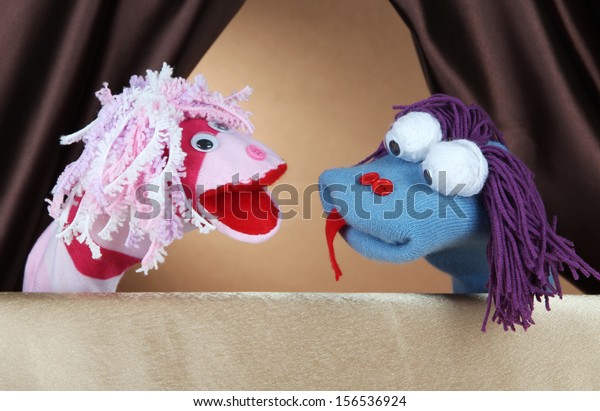 Puppet show on brown\
background