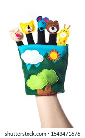 Puppet theater of doll animals. Hand wearing finger puppets: pig, lion, bear, mouse and giraffe. Animal finger puppets show.