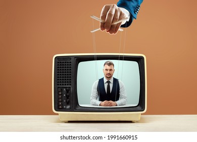 The puppeteer's male hand manipulates the news announcer, fake news, deception. The concept of shadow government, world conspiracy, manipulation, control, tabloids