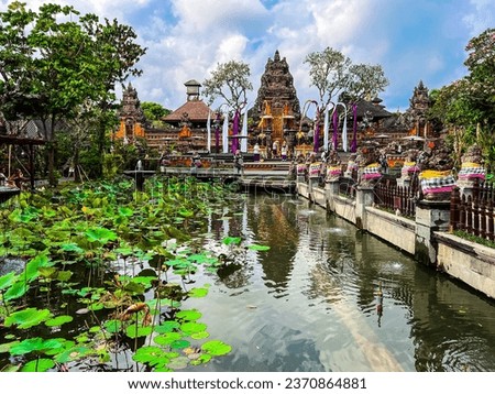 Pura Taman Saraswati Temple in Ubud, Bali, Indonesia, October 2023
Beautiful Asian landscape, lotus flower pond water garden, ancient red Hindu temple, blue sky