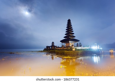 Pura Ulun Danu temple at night with moon on a lake Bratan, Bali, Indonesia