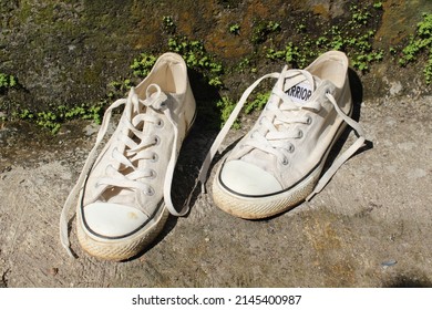 PURBALINGGA,INDONESIA - APRIL 13,2022: White Canvas Shoe Pair Rubber Sole Wall Background