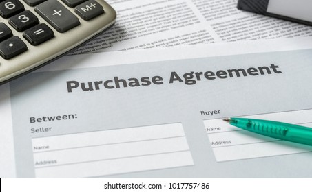 A Purchase Agreement With A Pen On A Desk