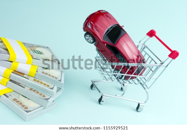 purchase auto dealership and rental car concept. red\
car money shopping\
cart