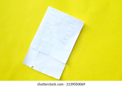 Purchase Receipt Paper Flat Lay On Yellow Background. Holiday Shopping Concept