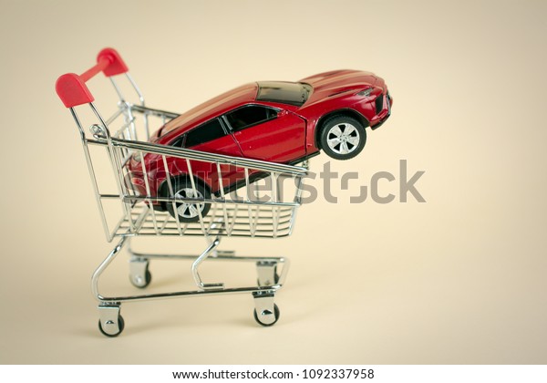 purchase selling auto dealership and rental car\
concept. red car shopping\
cart