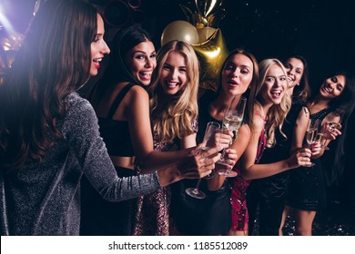 Pure celebration. Beautiful young women in evening gown holding champagne glasses and looking at camera with smile while celebrating in nightclub
 - Powered by Shutterstock