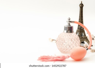 Pure Essence Perfumes, Fragrance Of France And Romantic Mood In Paris Concept Theme With A Vintage Bottle Of French Perfume Next To The Eiffel Tower Isolated On White Background With Copy Space