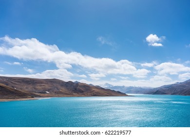 pure landscape in tibet, holy lake and mountain with blue sky on tibetan plateau