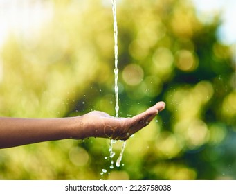 Pure and precious to nature. Shot of hands held out to catch a stream of water outside. - Shutterstock ID 2128758038