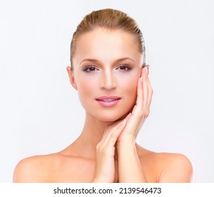 Pure radiance. Portrait of a beautiful blonde woman with flawless skin gazing at you, isolated on white.