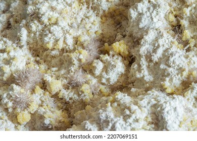 Pure Raw Block Of Sulphur With A Powder-like Texture. Natural Sulfur Mineral Specimen With Celestine Crystals On Its Surface