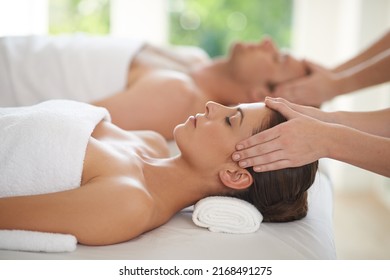 Pure relaxation. Closeup shot of a young woman and her husband receiving head massages at a spa. - Powered by Shutterstock